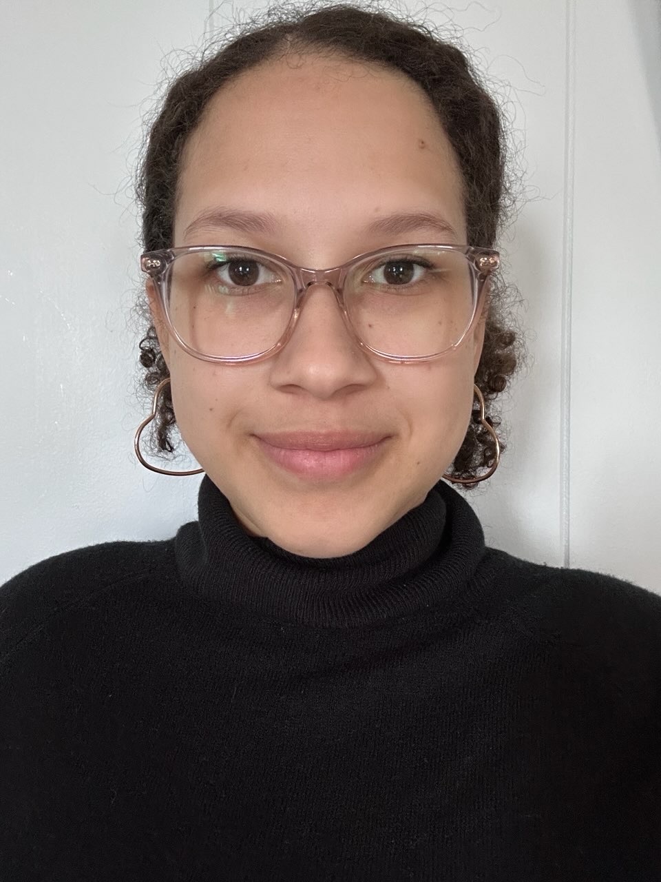 Maddie Alvarado, a latino woman with brown hair and glasses