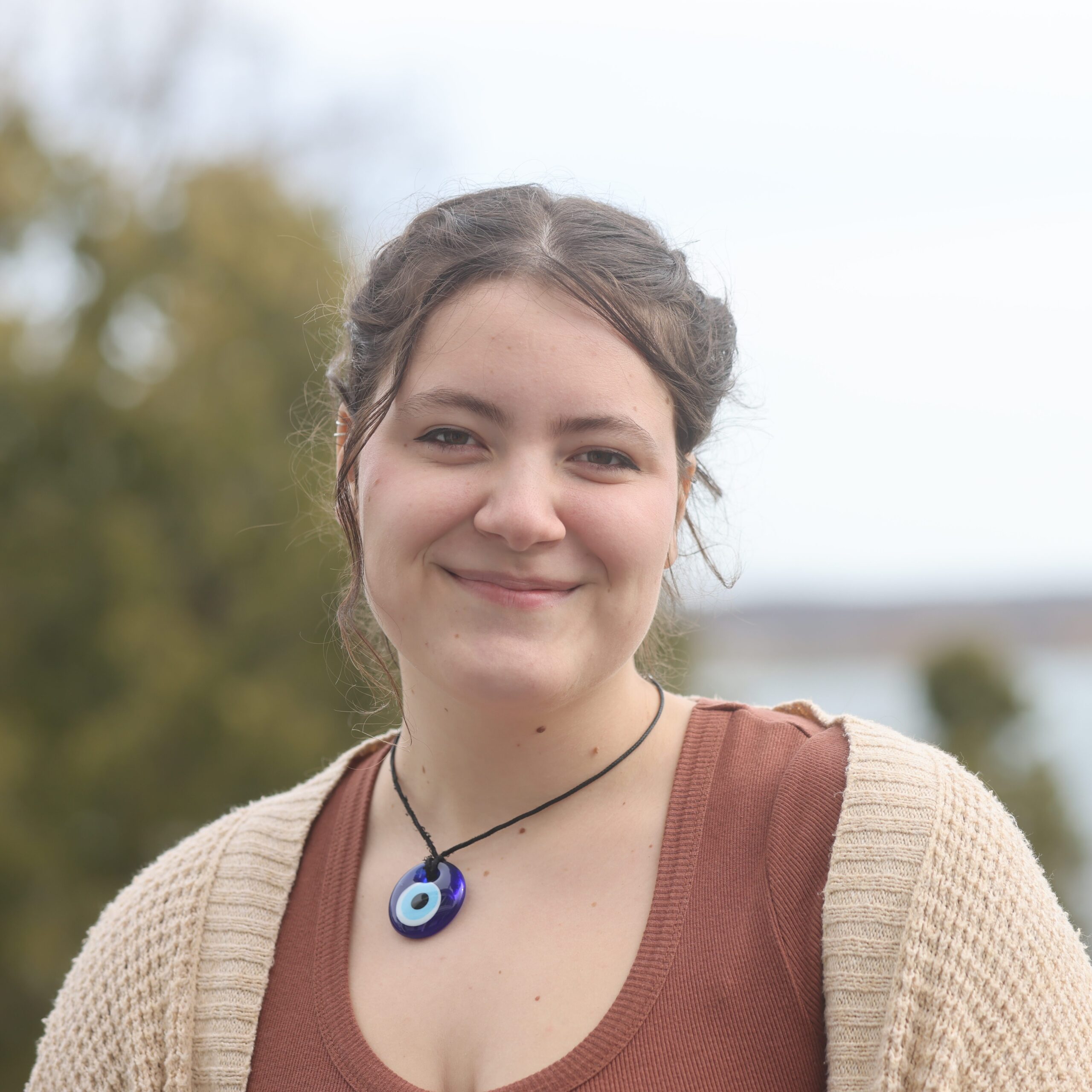 woman wearing necklace standing outside