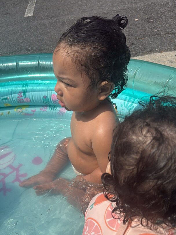 Little boy sitting in baby pool