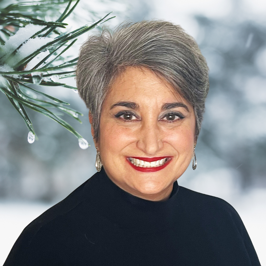 woman with short grey hair in front of winter tree
